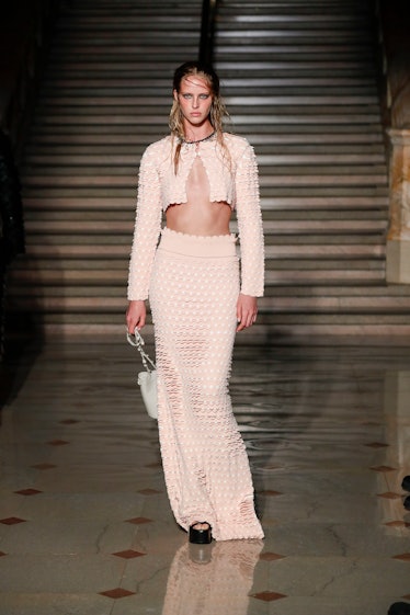 Model on the NY Fashion Week Fall 2022 runway in an Altuzarra nude long skirt and a nude cropped coa...