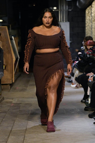 Model on the NY Fashion Week Fall 2022 runway in Eckhaus Latta dark brown crop top and long skirt wi...