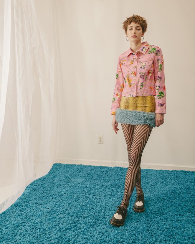 Model wearing a designer Colin Locascio's pink jacket and a yellow snake leather dress
