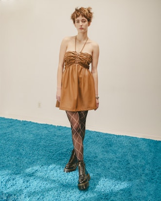 Model wearing a designer Colin Locascio's short beige dress