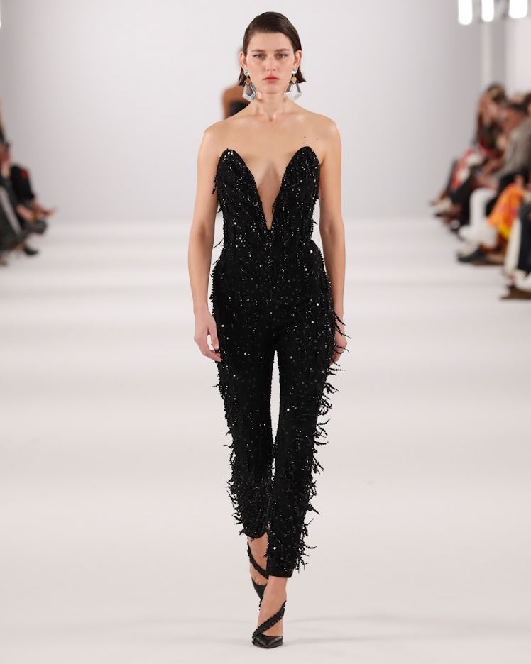 Model on the NY Fashion Week Fall 2022 runway in a Carolina Herrera black jumpsuit