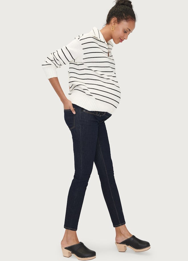 Pregnant woman modeling slim maternity jeans