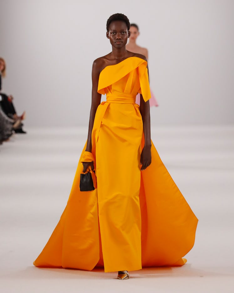 Model on the NY Fashion Week Fall 2022 runway in a Carolina Herrera orange maxi dress