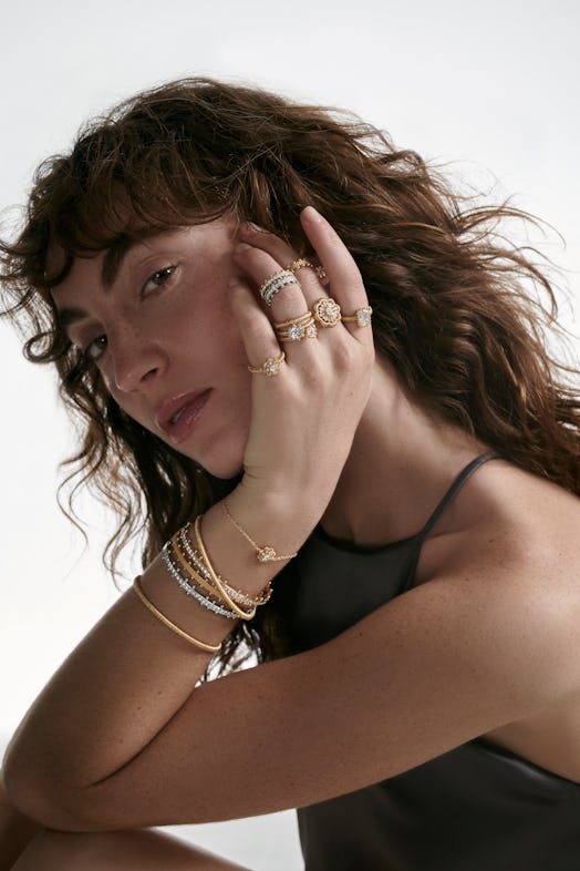 A model wearing a variety of oscar massin jewelry 