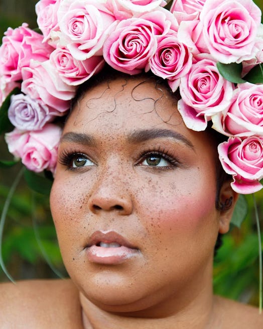 Lizzo in flower crown, freckles, green contacts