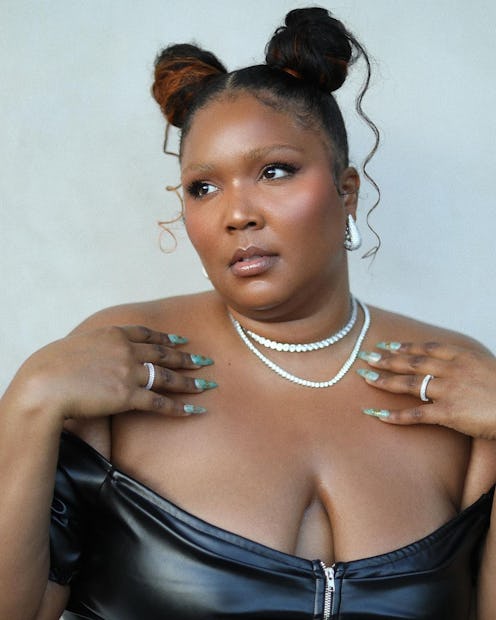 Lizzo with space buns and green nails