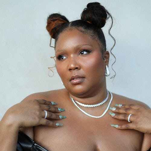 Lizzo with space buns and green nails