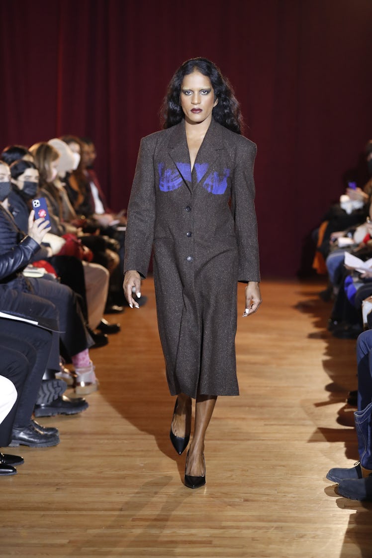Model on the NY Fashion Week Fall 2022 runway in a Puppets and Puppets long gray coat