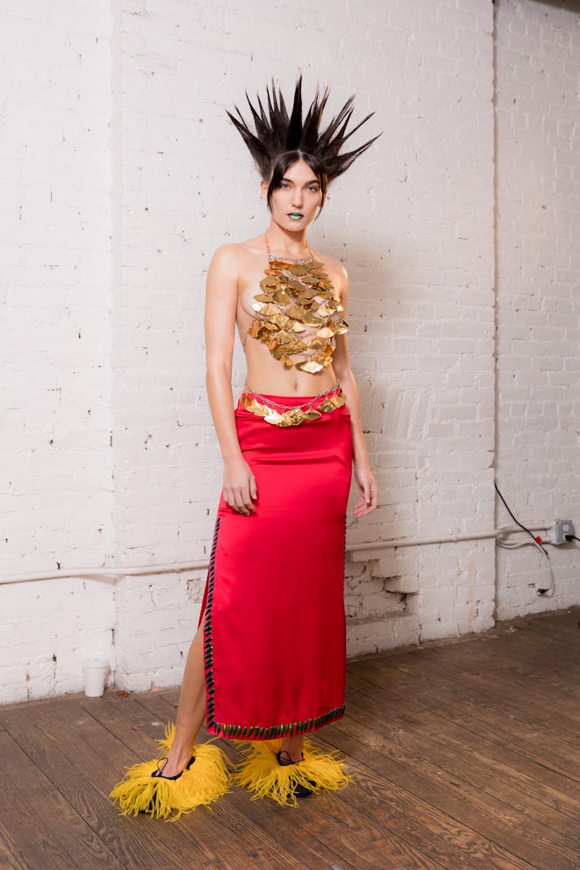 A model wearing red pants and black crown from Dauphinette's Fall 2022 collection.