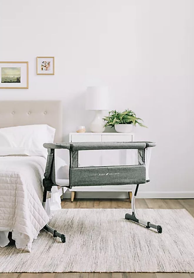 Lifestyle photo of baby bassinet next to bed
