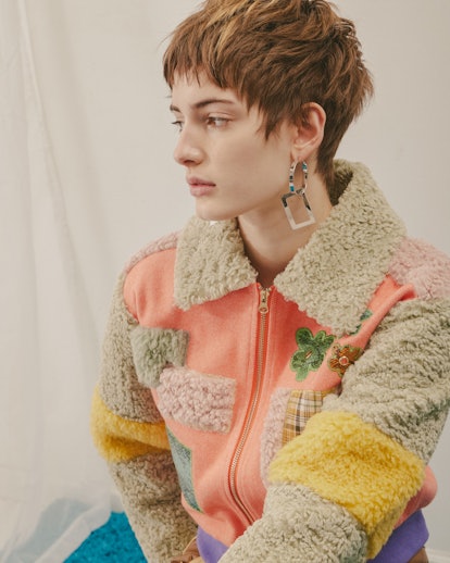 Model wearing a designer Colin Locascio's woolen ping, beige, and yellow jacket