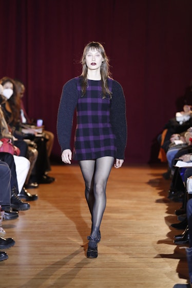 Model on the NY Fashion Week Fall 2022 runway in a Puppets and Puppets purple and black check patter...