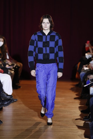 Model on the NY Fashion Week Fall 2022 runway in a Puppets and Puppets blue and black check pattern ...
