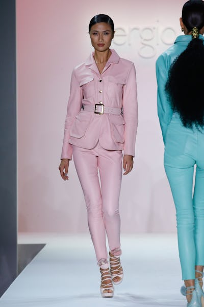 a model wearing a pink leather blazer and pants on the Sergio Hudson runway