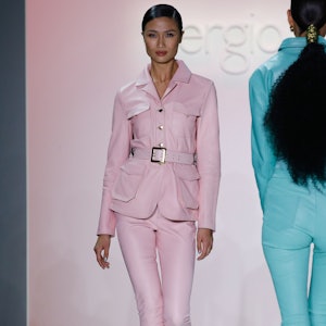 a model wearing a pink leather blazer and pants on the Sergio Hudson runway