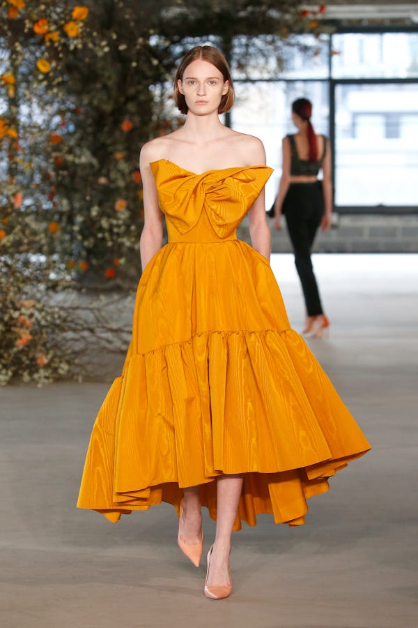 a model wearing a marigold full skirt A-line dress on the Jason Wu runway