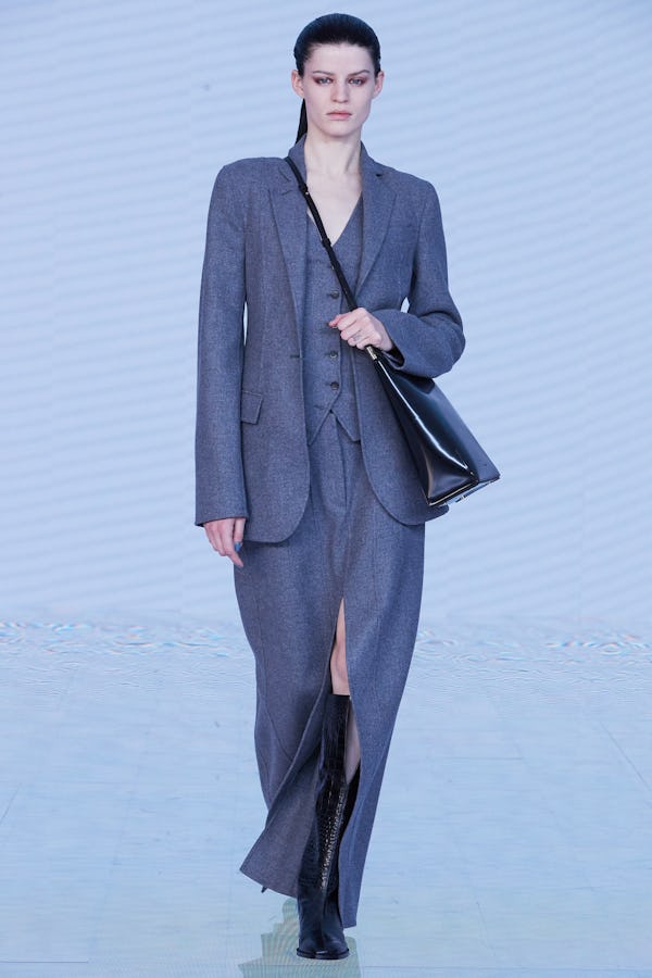 a model wearing a grey suit on the Peter Do runway