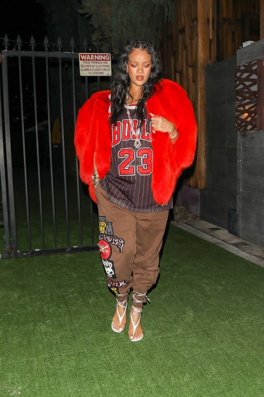 Rihanna wearing a heart-shaped jacket over a Chicago Bulls jersey. 