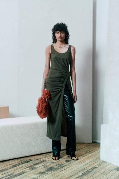 a model wearing a knit tank dress over black leather pants by Helmut Lang