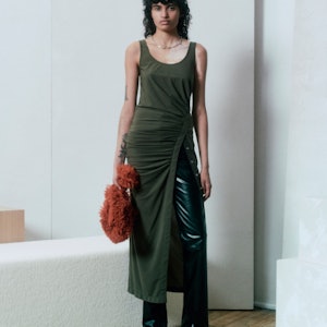 Model in knitted tank dress over black leather trousers by Helmut Lang