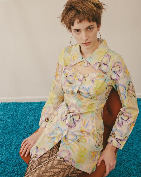 a model wearing an abstract floral print tunic top by Colin Locascio