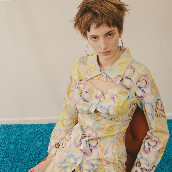 a model wearing an abstract floral print tunic top by Colin Locascio
