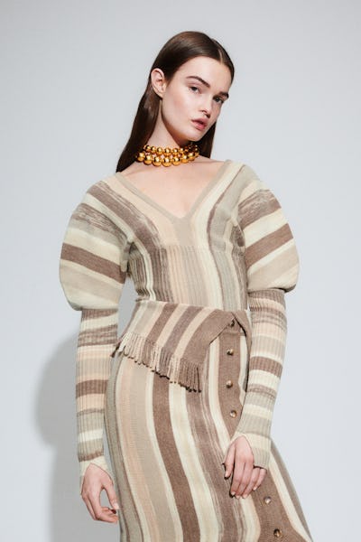 a model wearing a striped puff-sleeve knit top and skirt by Jonathan Simkhai