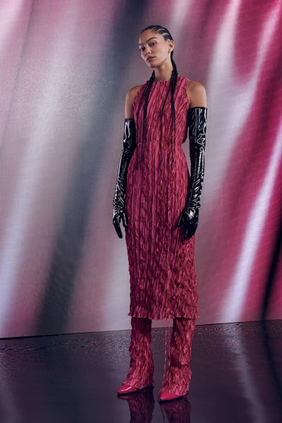 a model wearing a raspberry-colored crinkle silk tank dress over matching pants by LAPOINTE