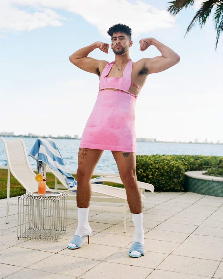 Bad Bunny flexing and wearing a pink dress in his Jacquemus campaign
