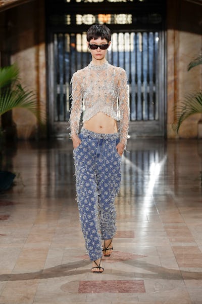 a model a rhinestone crop top and jeans on the PatBo runway