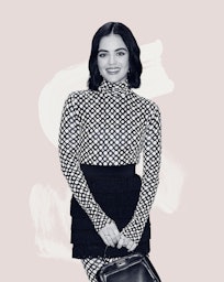 Lucy Hale wearing a patterned top and a black skirt while holding a leather handbag