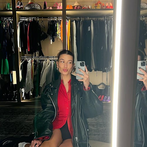 Hailey Bieber wears a black miniskirt.