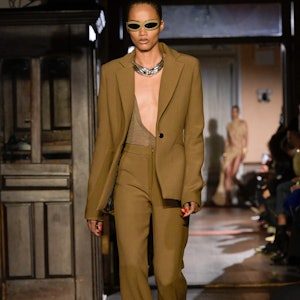 a model wearing a light brown suit on the LaQuan Smith runway