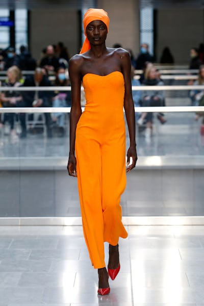a model wearing a marigold jumpsuit on the Victor Glemaud runway