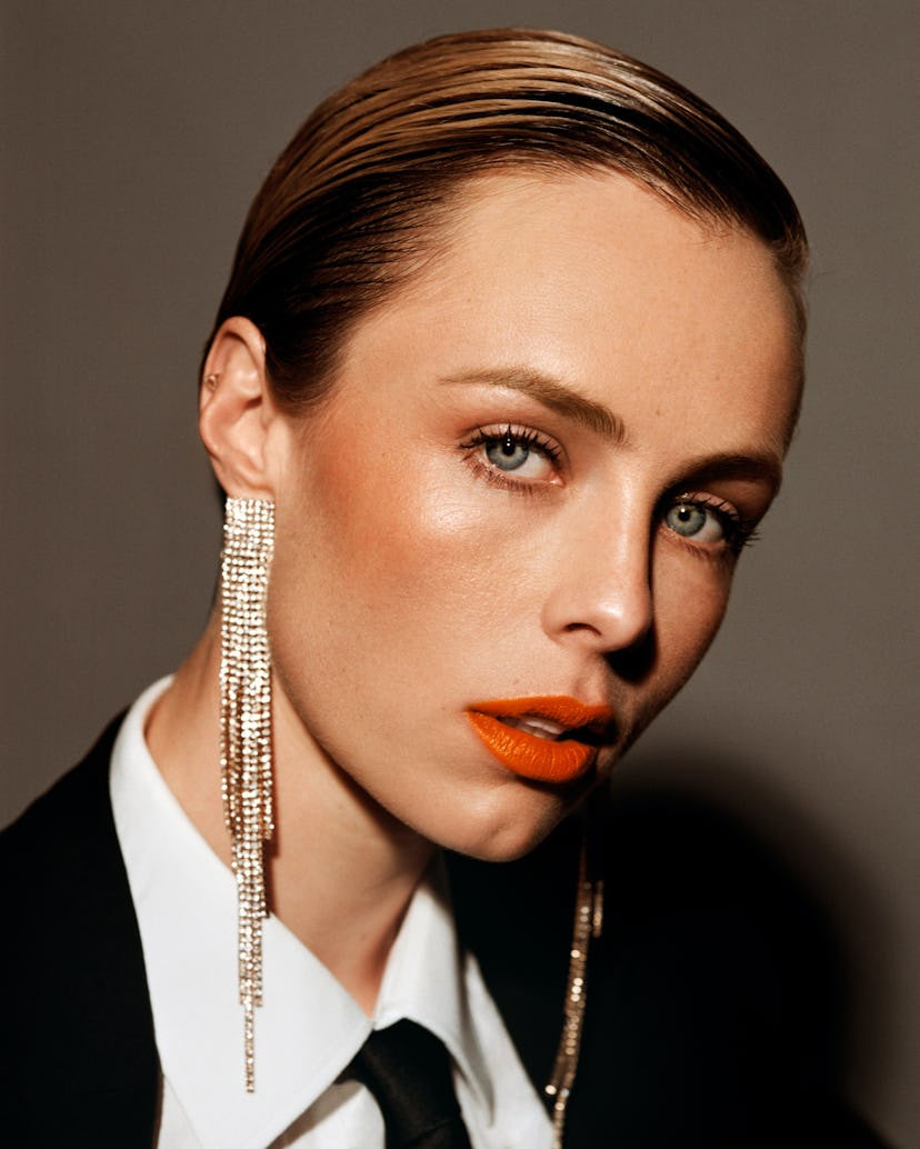 English model Edie Campbell wearing Hermès black jacket, Charvet white shirt styled with long earrin...
