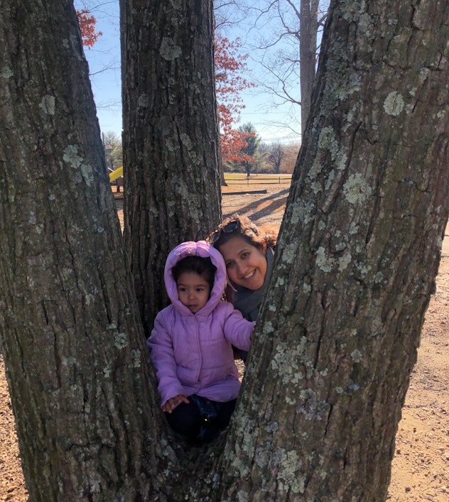 Kavita and her daughter in the crook of a tree