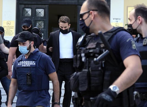 Babis Anagnostopoulos escorted by police, leaves the court in Athens.