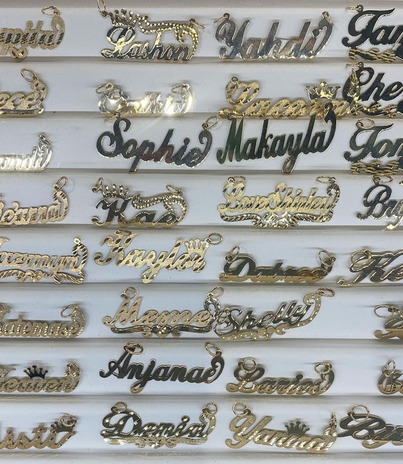 Gold nameplate necklaces on display