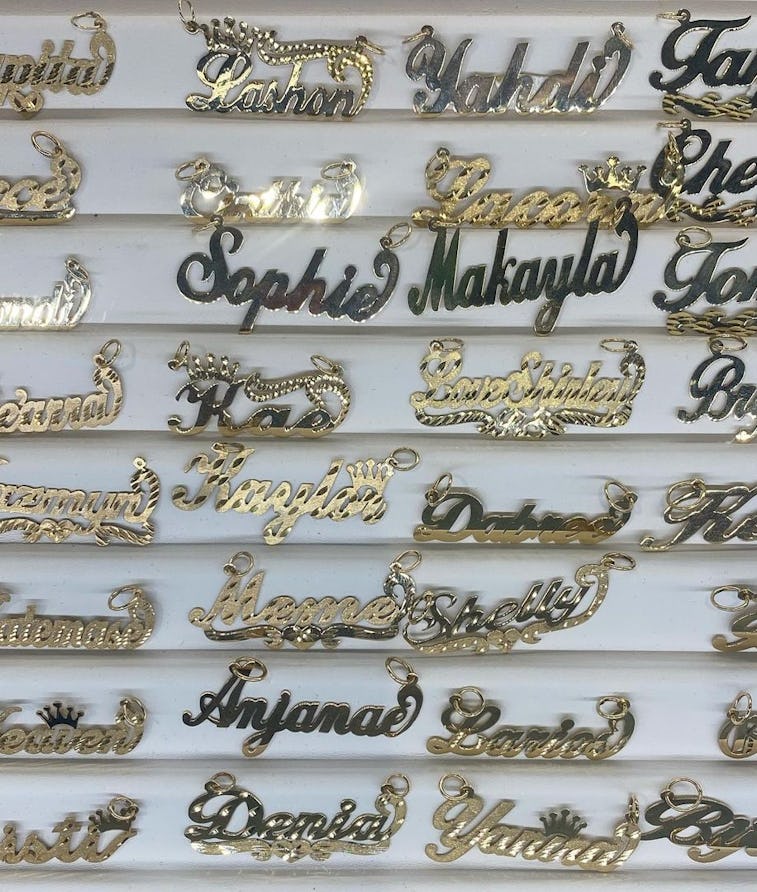 Gold nameplate necklaces on display