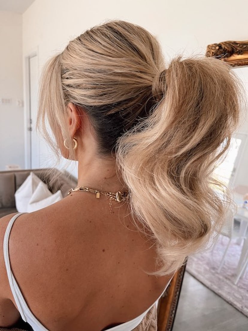Blonde hair pulled back into a ponytail with front pieces out.