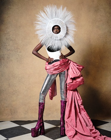 Model in white feathered headpiece and pink sash at Harris Reed fall 2022