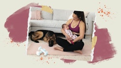 A mom in a nursing sports bra sitting with her baby in her lap and a dog next to them