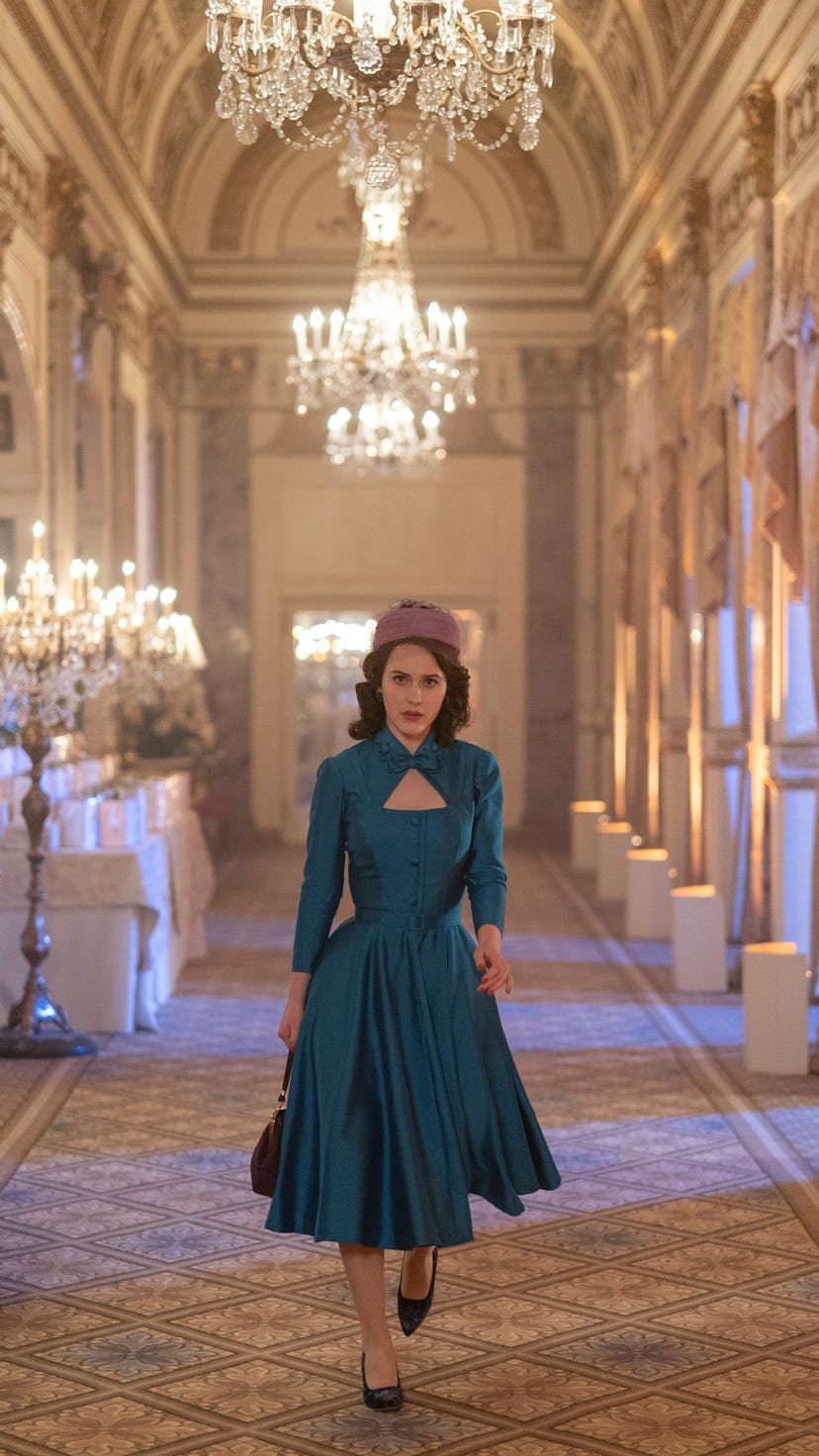 Rachel Brosnahan as Midge Maisel in a blue dress and pillbox hat.