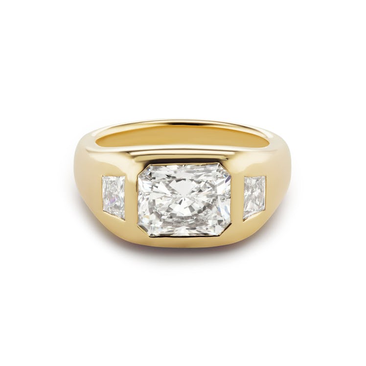 thick-set three-stone diamond engagement ring with a radiant cut center stone