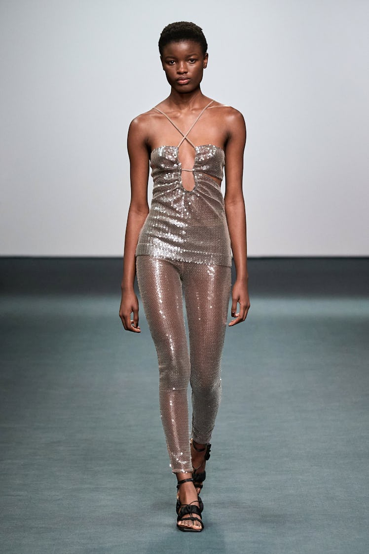 A model in a beige sequin top and leggings by Nensi Dojaka at the London Fashion Week Fall 2022
