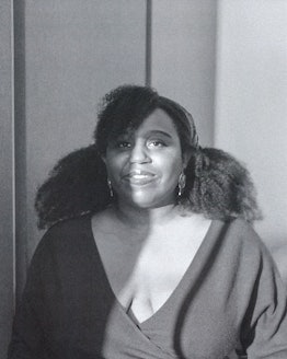 Maya Cade in a black v-neck shirt