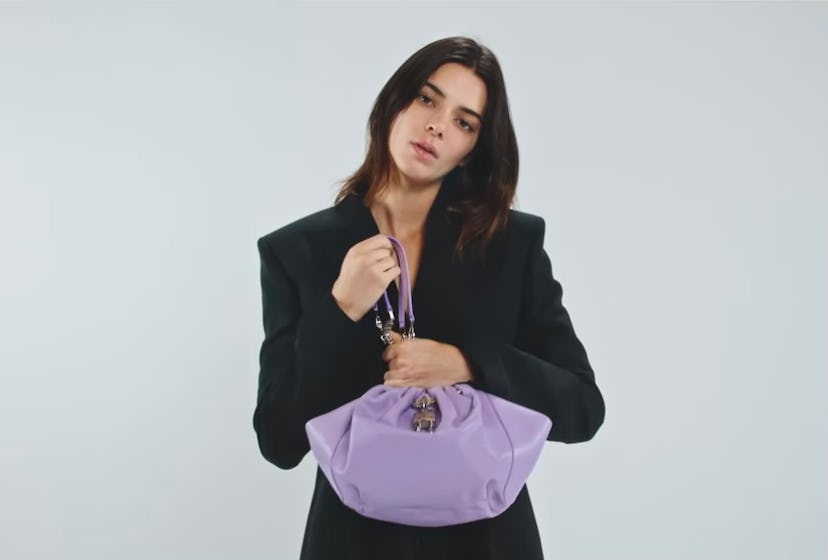 Kendall Jenner wearing a purple bag in Givenchy's Spring/Summer 2022 campaign video. 