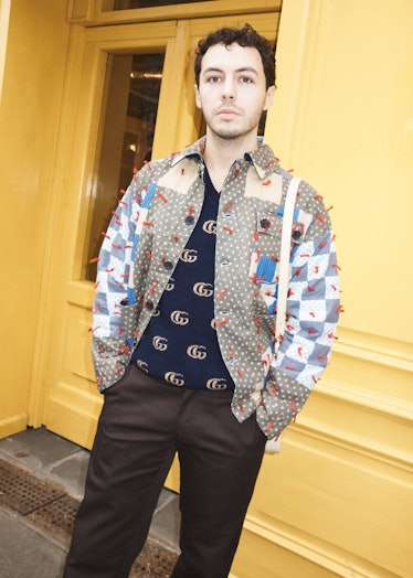A person wearing a patchwork jacket at London Fashion Week