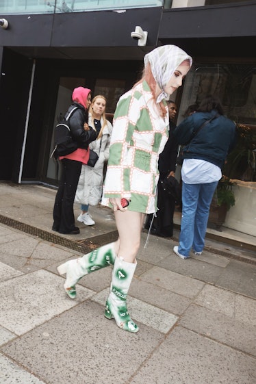 A person wearing a checkered jacket at London Fashion Week