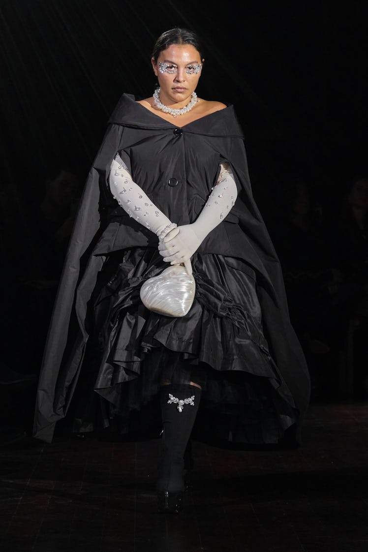 A model in a black gown and silver gloves by Simone Rocha at the London Fashion Week Fall 2022